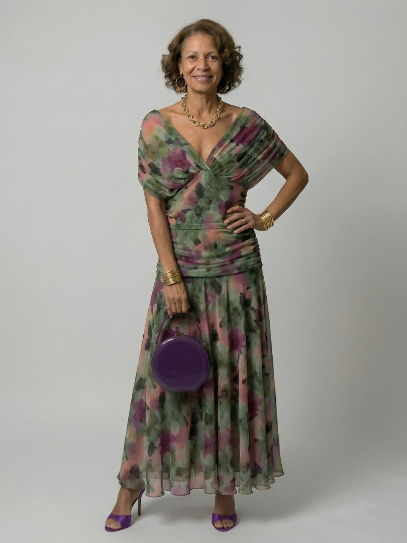 Woman wearing a purple watercolor floral mesh maxi dress with draped crossover neckline and ruched waist - view 12