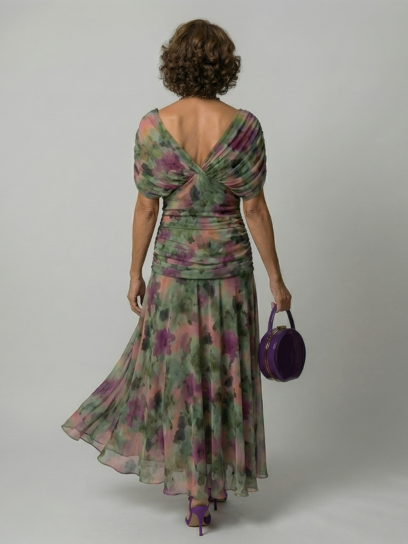 Woman wearing a purple watercolor floral mesh maxi dress with draped crossover neckline and ruched waist - view 14