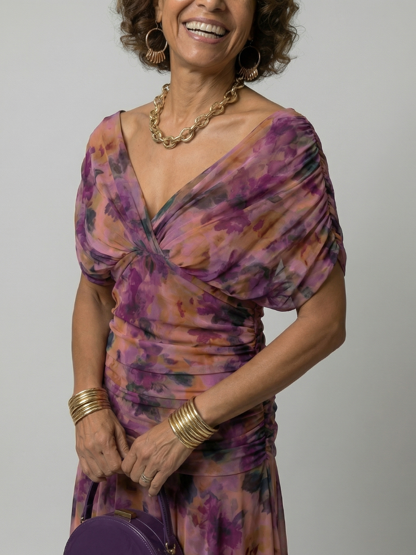 Woman wearing a purple watercolor floral mesh maxi dress with draped crossover neckline and ruched waist - view 2