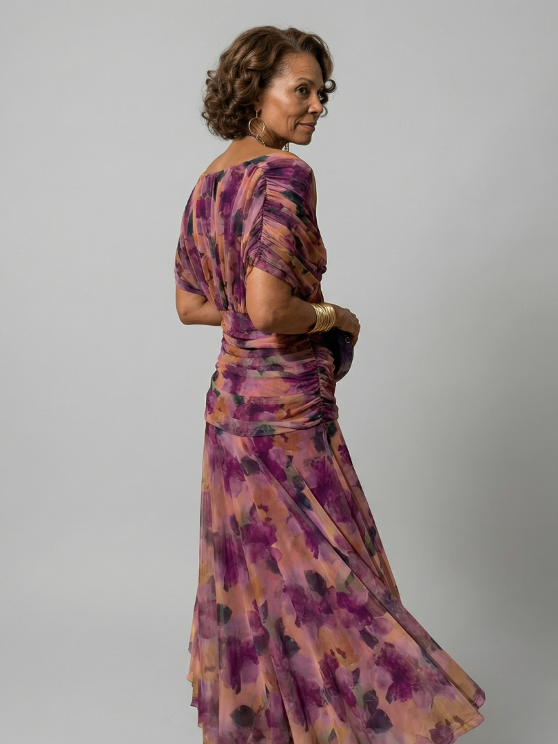 Woman wearing a purple watercolor floral mesh maxi dress with draped crossover neckline and ruched waist - view 3