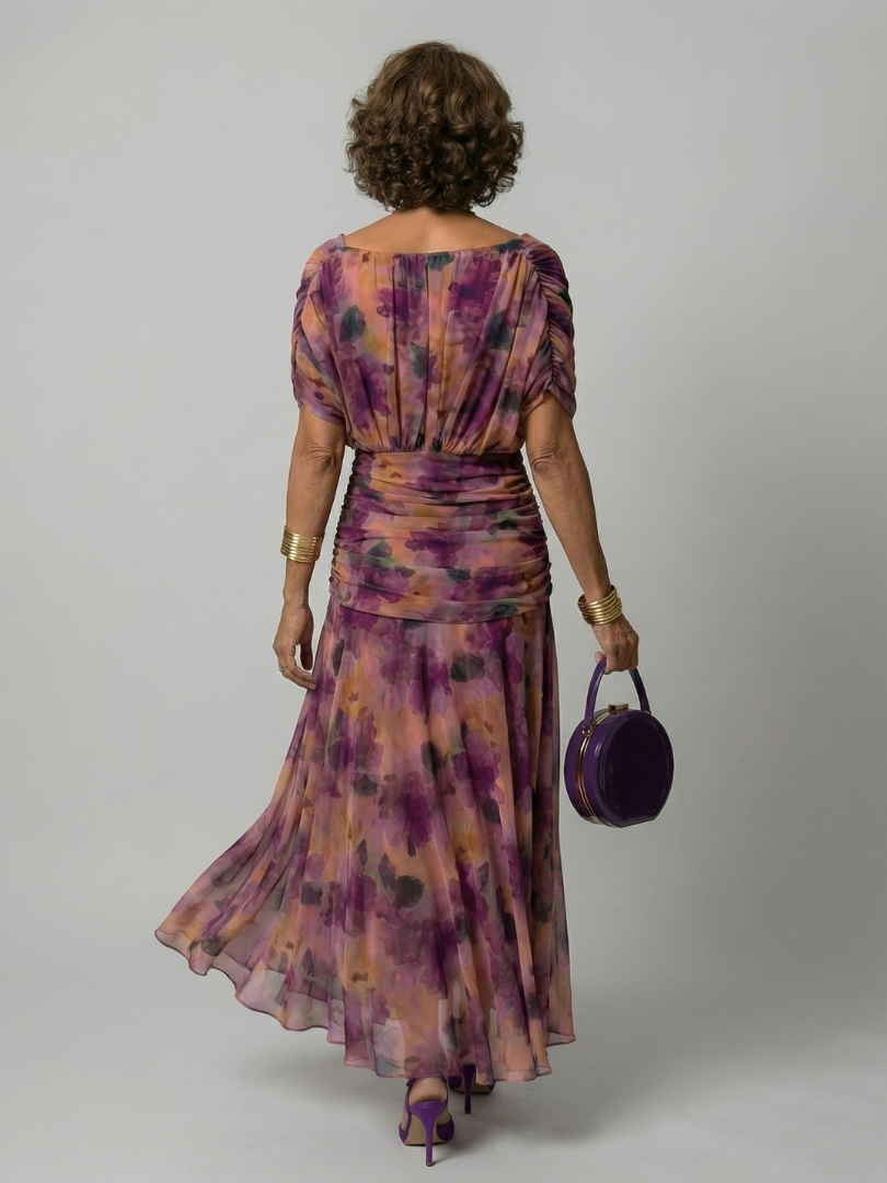 Woman wearing a purple watercolor floral mesh maxi dress with draped crossover neckline and ruched waist - view 4