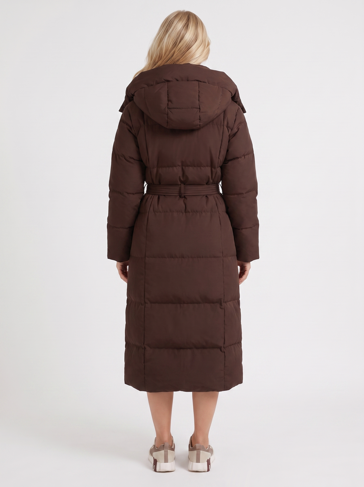 Woman wearing a long hooded quilted puffer jacket with tie belt - view 11