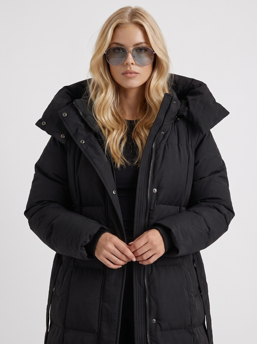 Woman wearing a long hooded quilted puffer jacket with tie belt - view 2