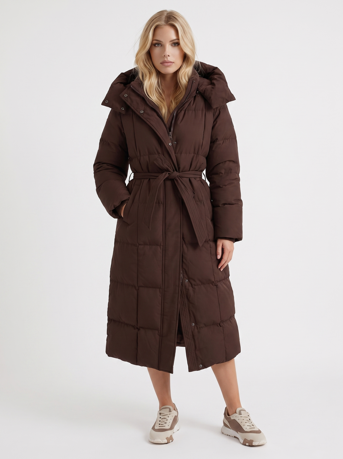 Woman wearing a long hooded quilted puffer jacket with tie belt - view 7