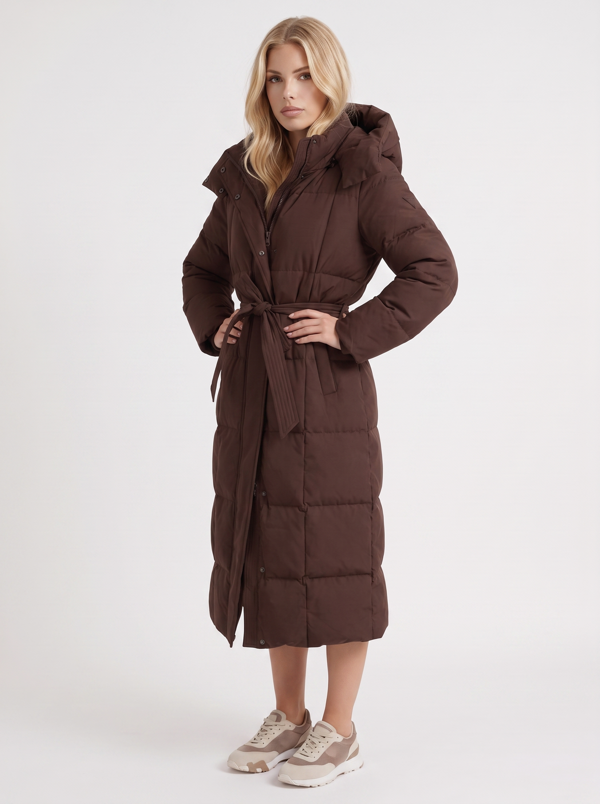Woman wearing a long hooded quilted puffer jacket with tie belt - view 9