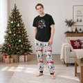 Whole family in black Merry Christmas tees and festive print jogger pajamas beside a Christmas tree - view 2
