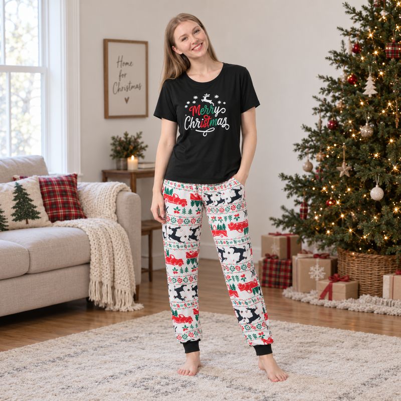 Whole family in black Merry Christmas tees and festive print jogger pajamas beside a Christmas tree - view 3