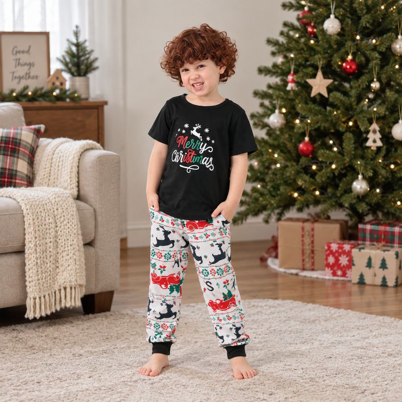 Whole family in black Merry Christmas tees and festive print jogger pajamas beside a Christmas tree - view 4