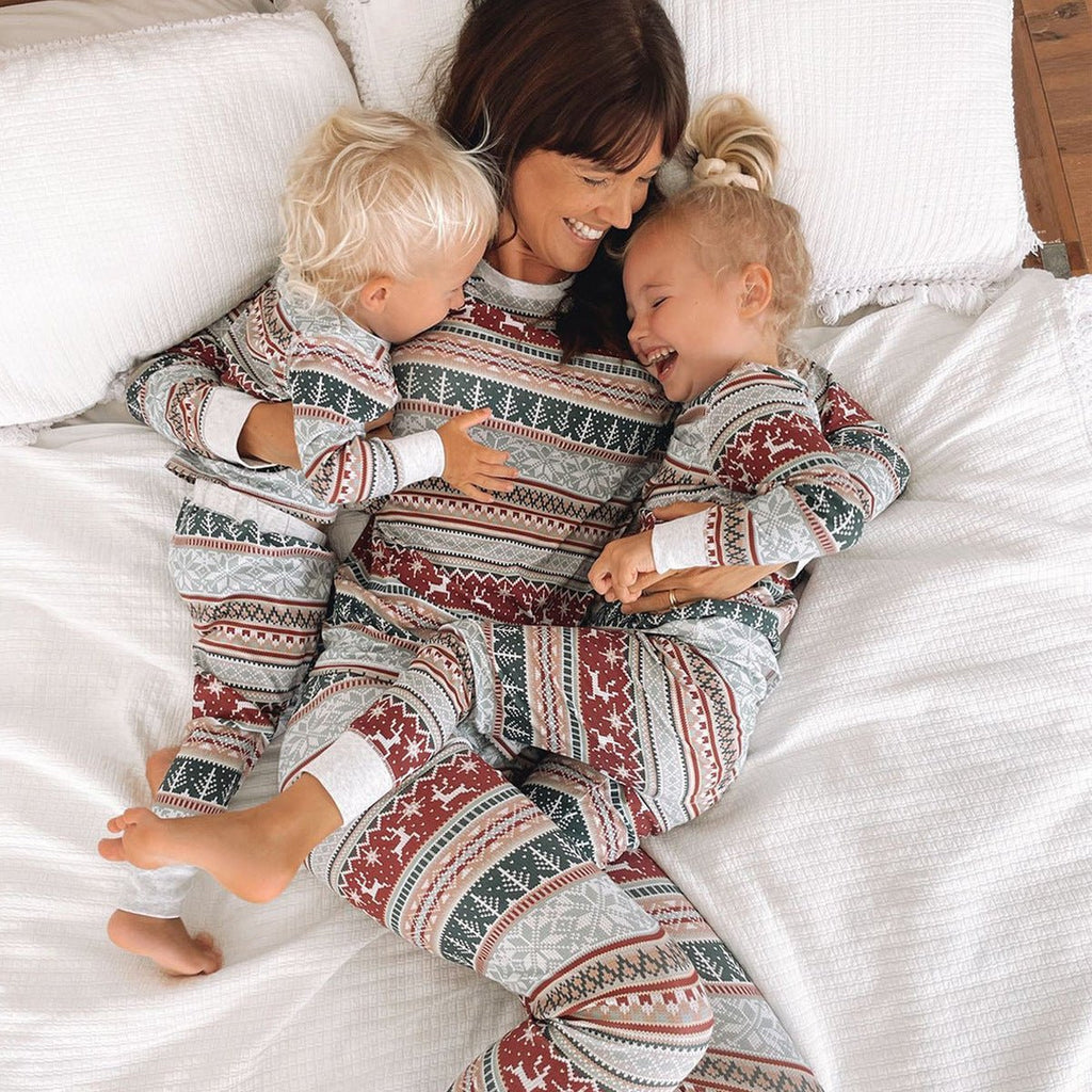 Family wearing matching Fair Isle reindeer print Christmas pajamas with white ribbed cuffs - view 11