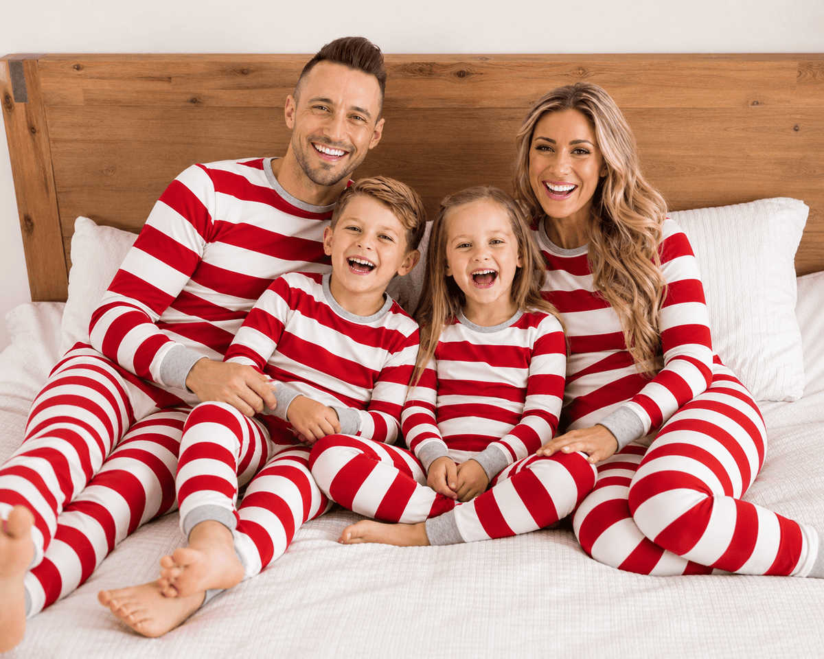 Family wearing matching red and white striped Christmas pajamas with gray cuffs - view 5