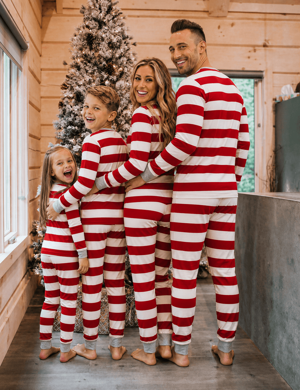 Family wearing matching red and white striped Christmas pajamas with gray cuffs - view 6
