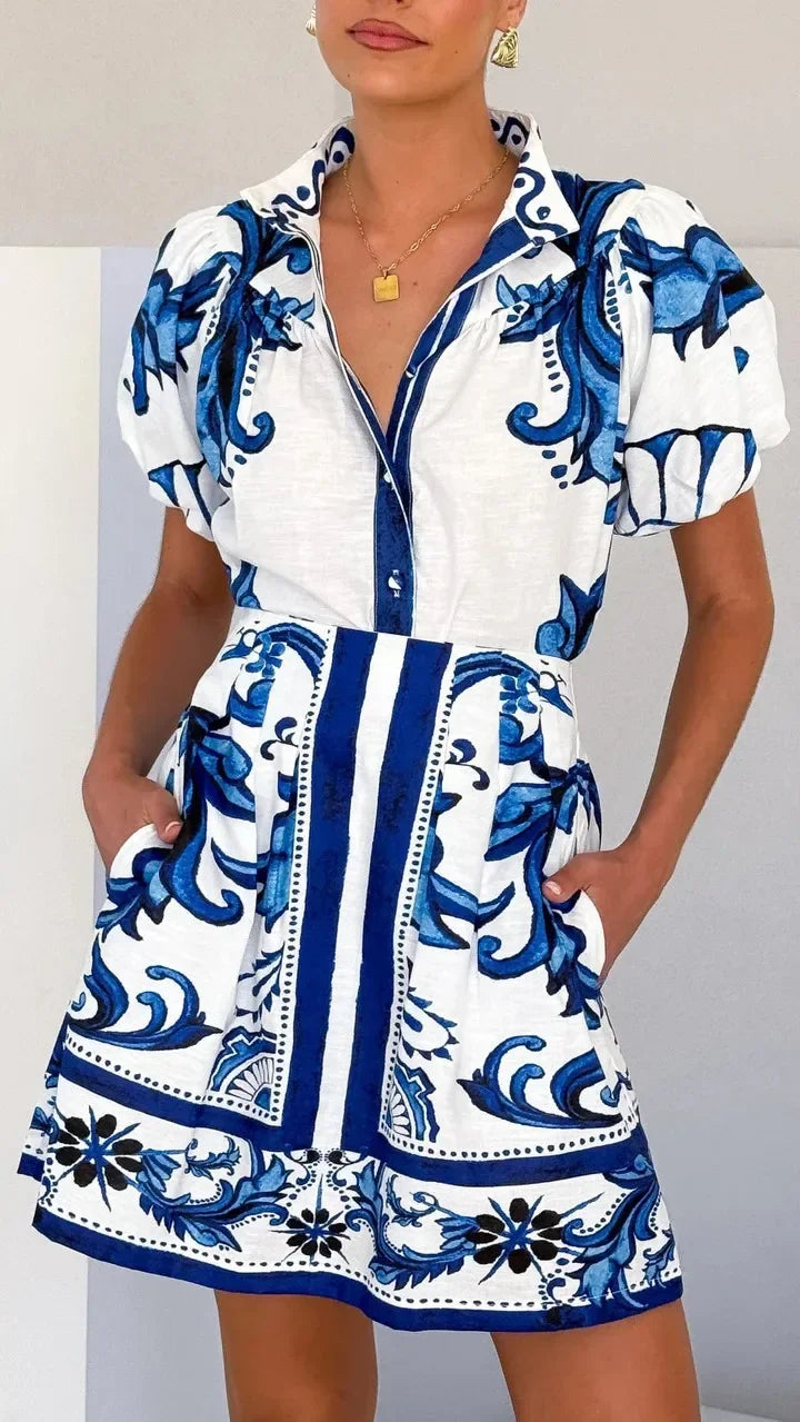 Woman wearing a pink and red tile print puff sleeve cocktail dress with pockets - view 15