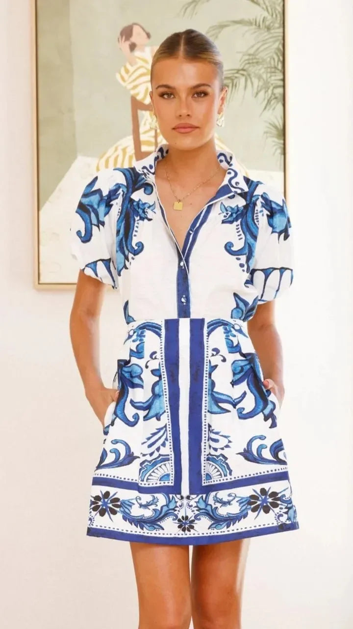Woman wearing a pink and red tile print puff sleeve cocktail dress with pockets - view 16