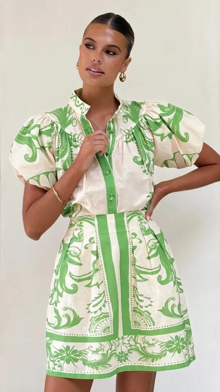 Woman wearing a pink and red tile print puff sleeve cocktail dress with pockets - view 22