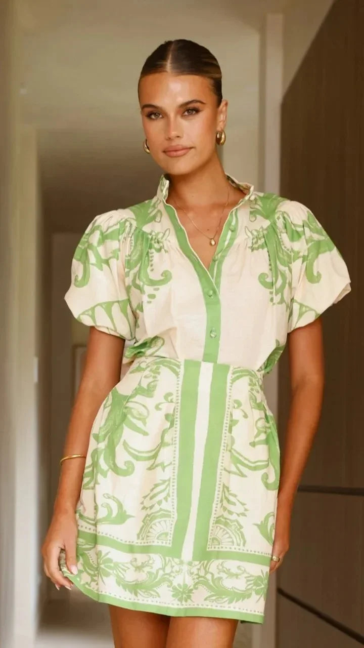 Woman wearing a pink and red tile print puff sleeve cocktail dress with pockets - view 23
