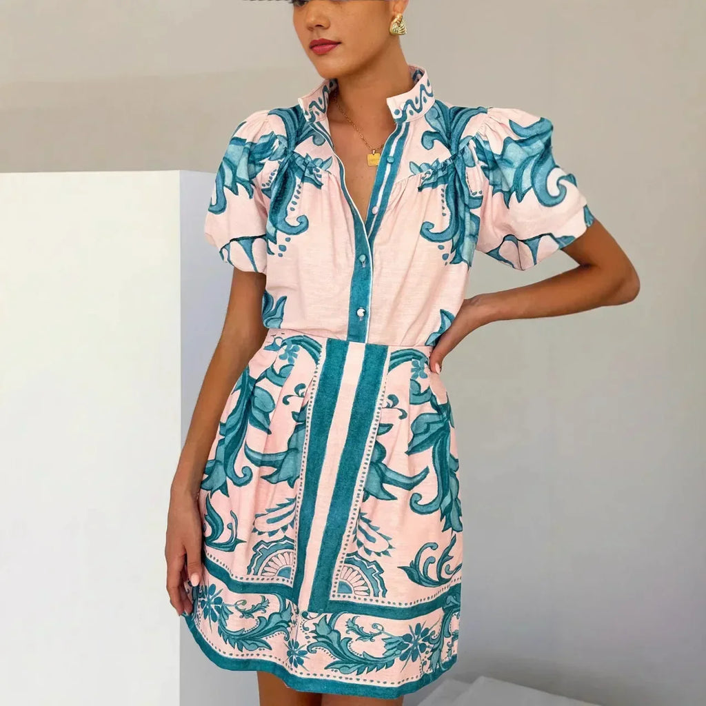 Woman wearing a pink and red tile print puff sleeve cocktail dress with pockets - view 6