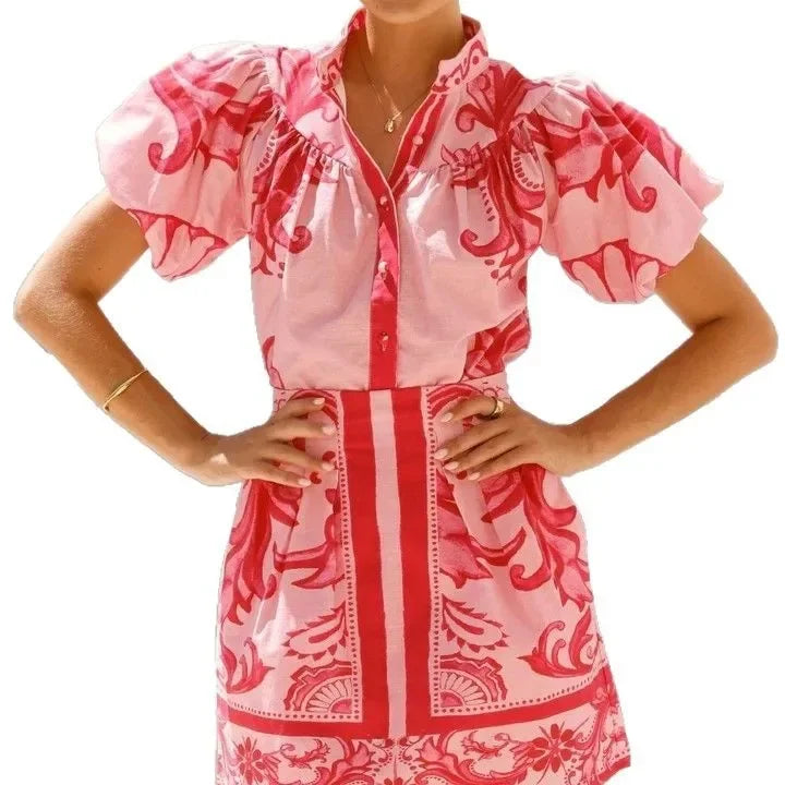 Woman wearing a pink and red tile print puff sleeve cocktail dress with pockets - view 8