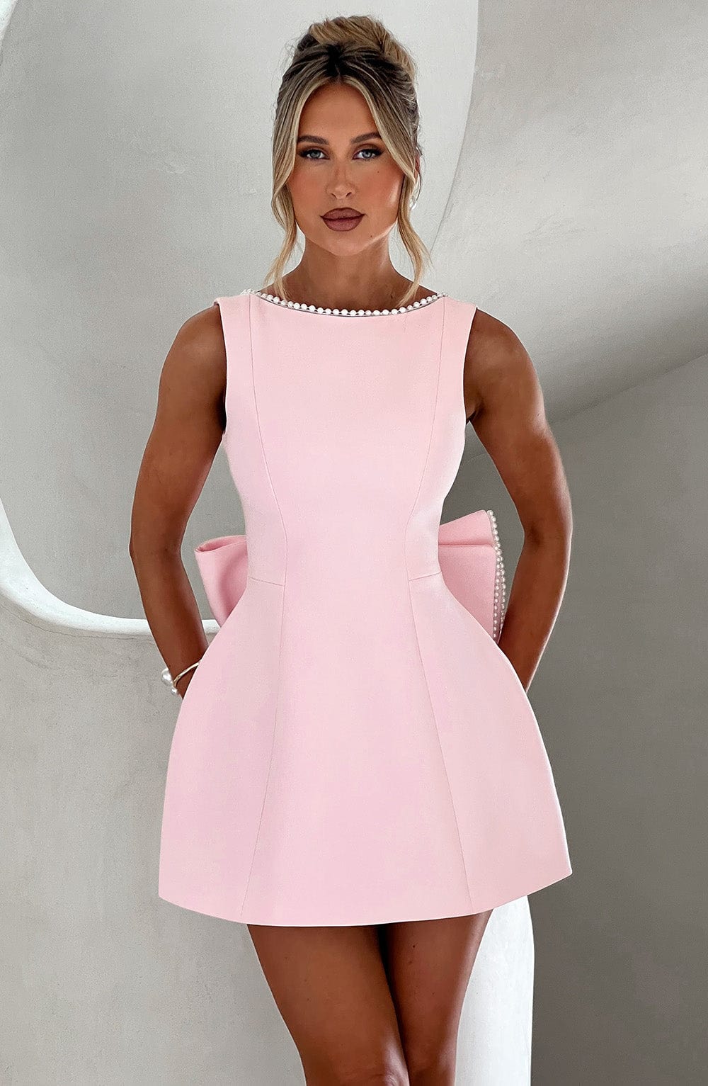 Sleeveless A-line cocktail mini dress with pearl-effect trim and oversized back bow - view 11