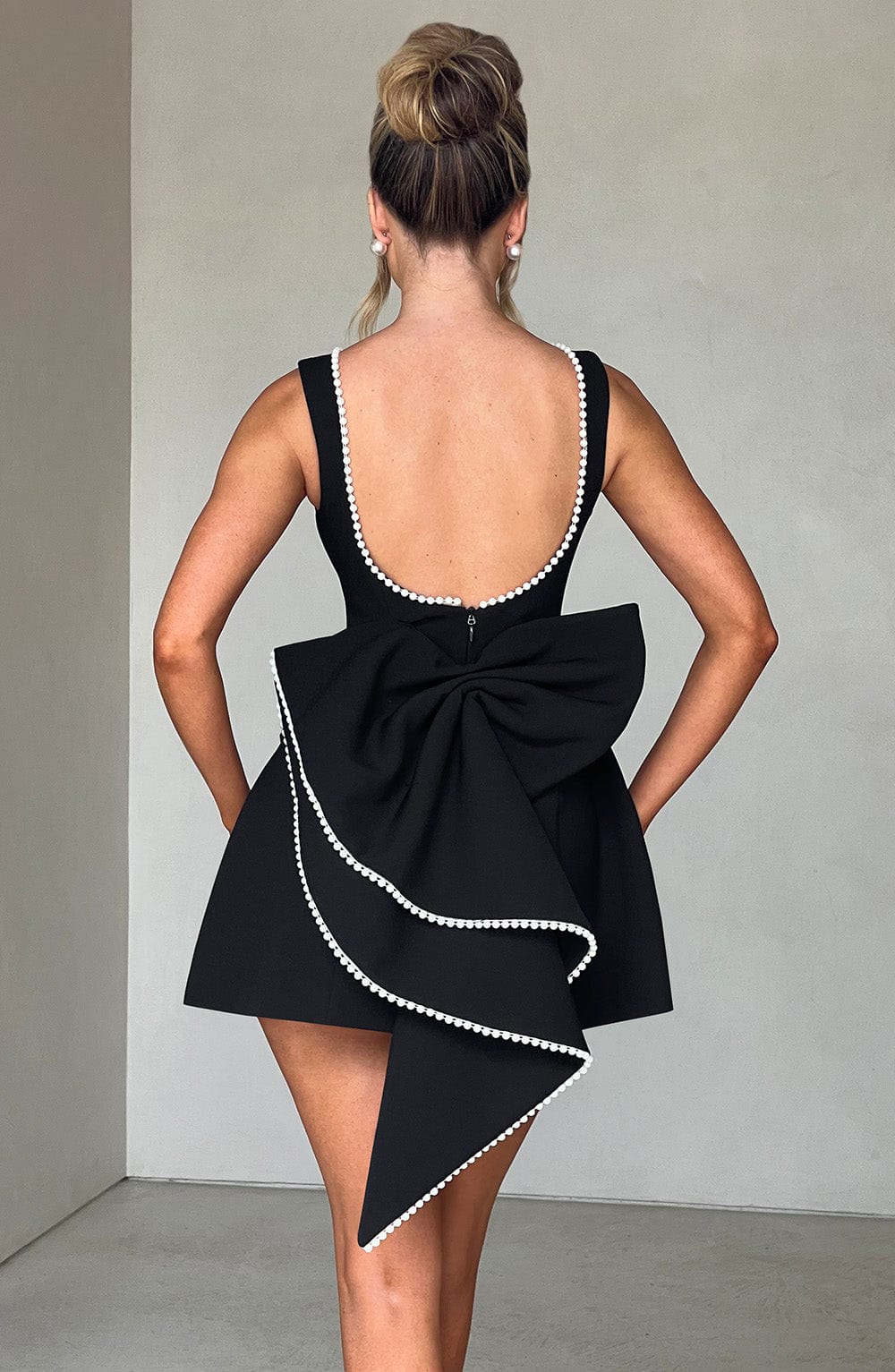 Sleeveless A-line cocktail mini dress with pearl-effect trim and oversized back bow - view 17