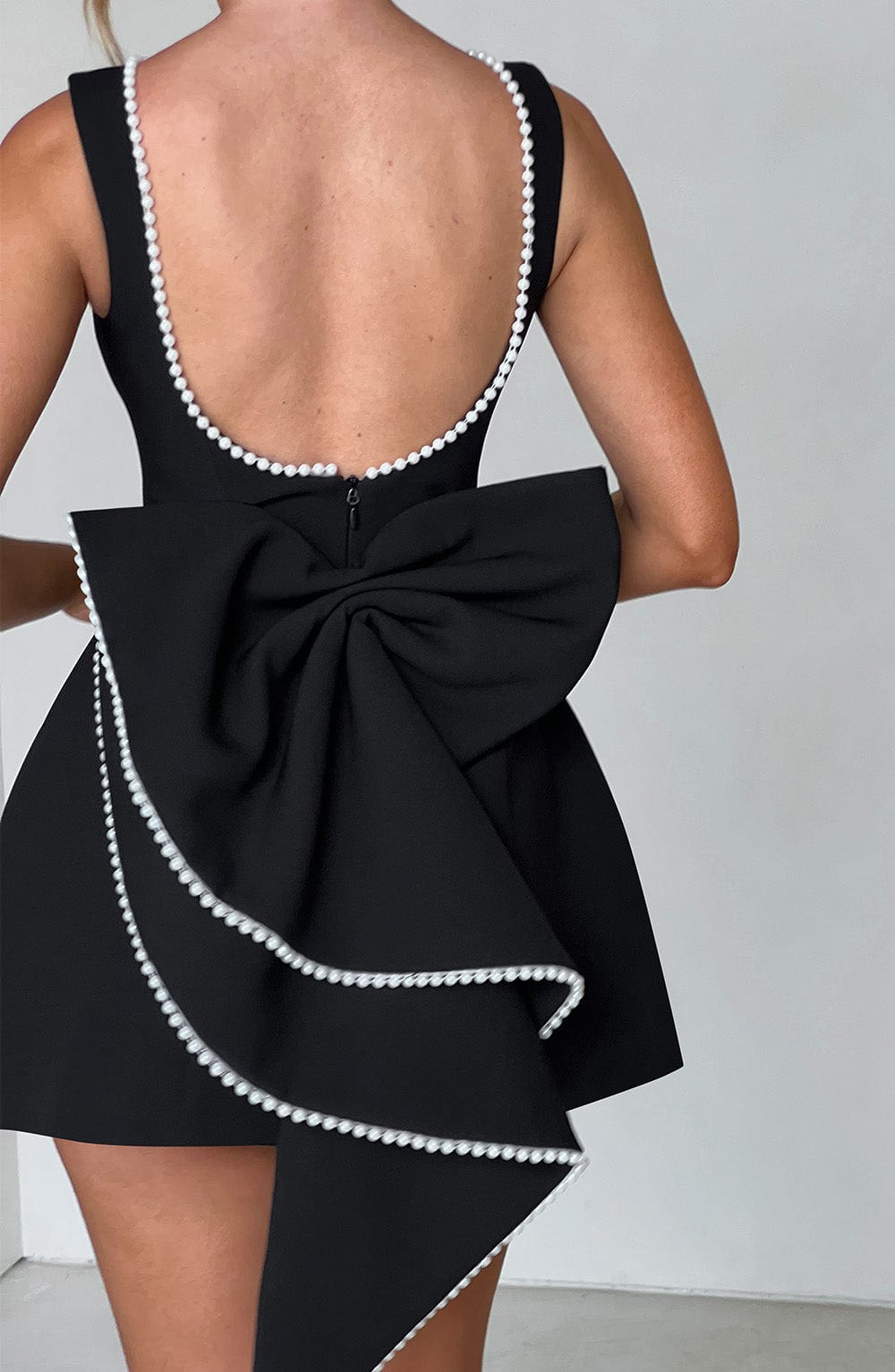 Sleeveless A-line cocktail mini dress with pearl-effect trim and oversized back bow - view 18