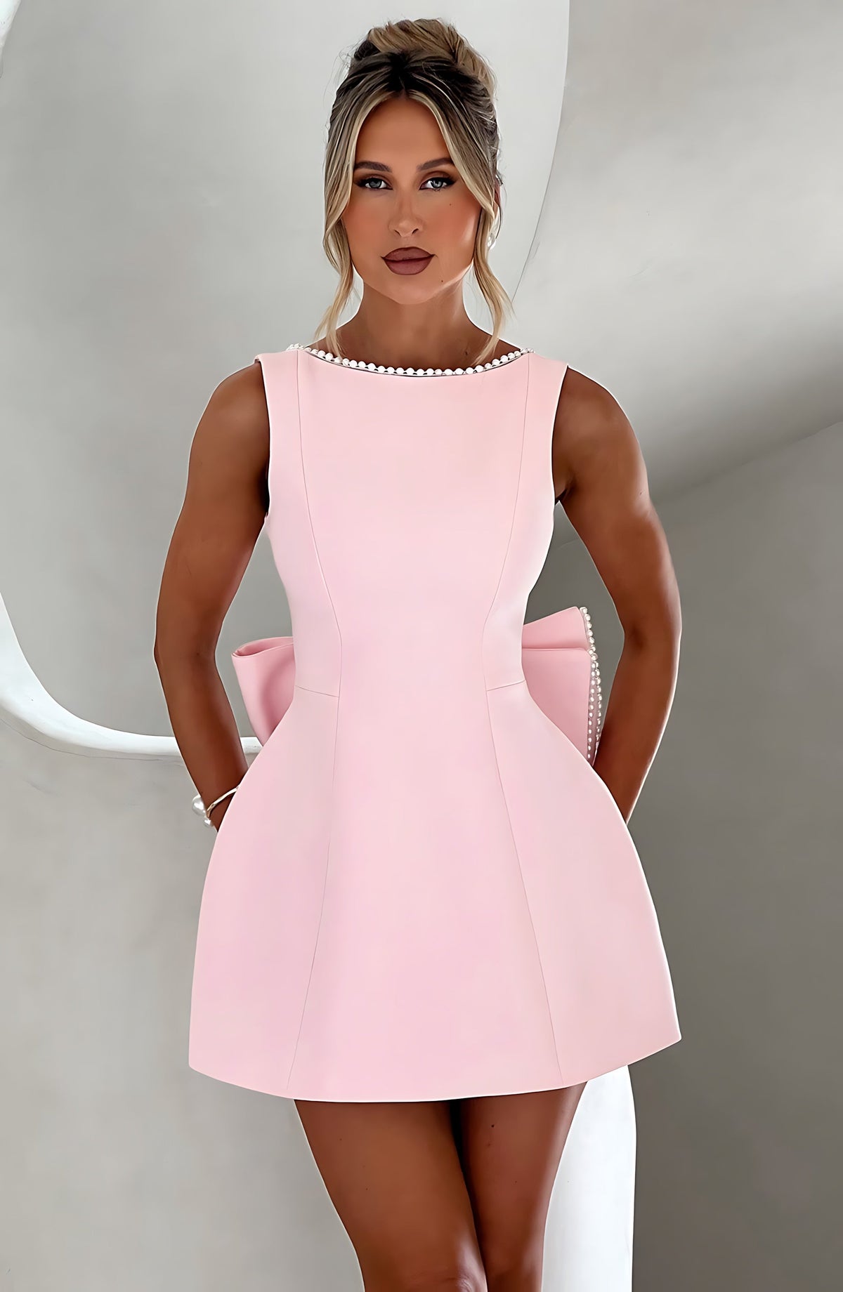 Sleeveless A-line cocktail mini dress with pearl-effect trim and oversized back bow - view 2