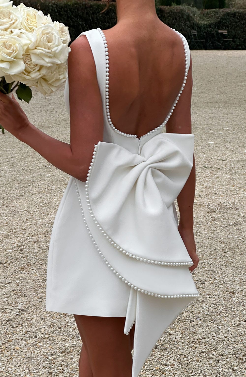 Sleeveless A-line cocktail mini dress with pearl-effect trim and oversized back bow - view 22