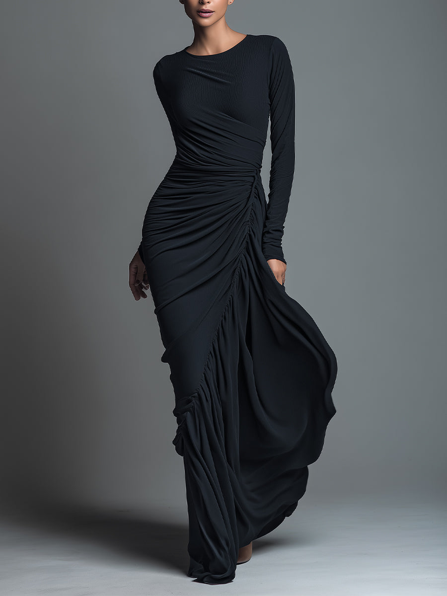 Woman wearing a black long sleeve ruched maxi dress with a draped skirt