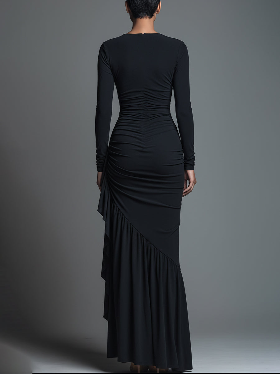 Woman wearing a black long sleeve ruched maxi dress with a draped skirt - view 6