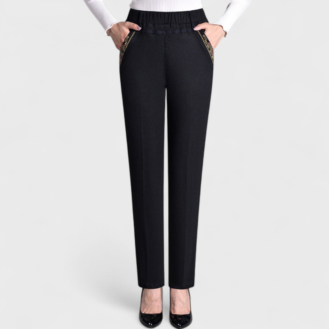 Women's elastic waist straight leg jeans with embroidered side pocket trim and pressed front crease