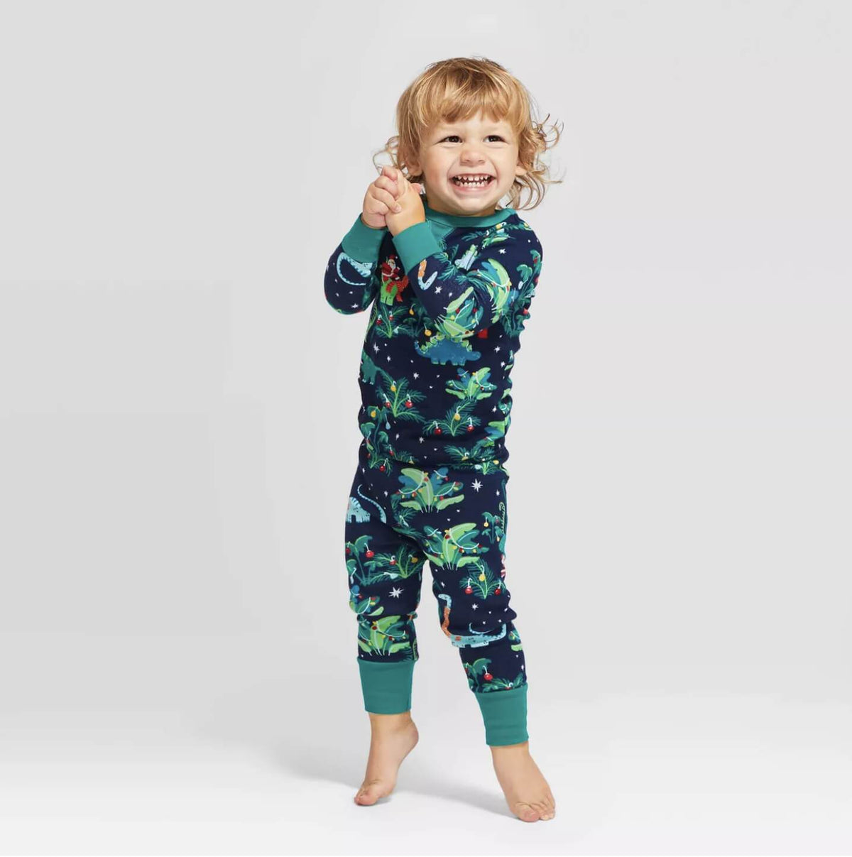 Matching family Christmas pajamas with dinosaur print on navy and teal ribbed cuffs - view 2