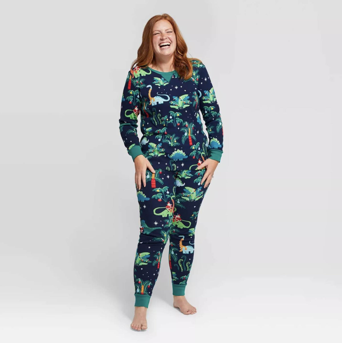 Matching family Christmas pajamas with dinosaur print on navy and teal ribbed cuffs - view 5
