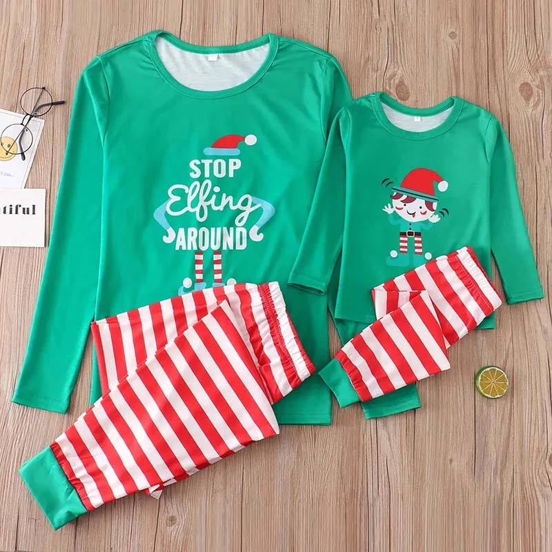 Family holiday pajamas with green elf print tops and red and white striped pants - view 7
