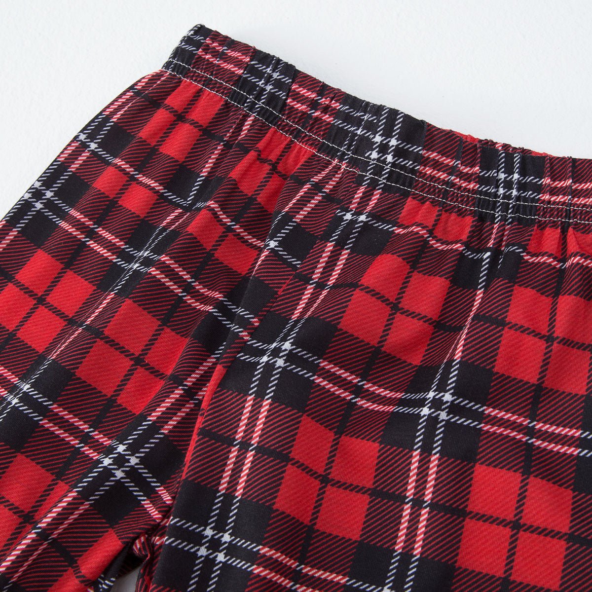 Matching family Christmas pajamas with red truck graphic raglan top and red plaid pants - view 10
