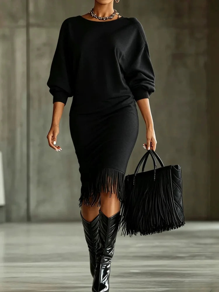 Woman wearing a long sleeve midi sweater dress with balloon sleeves and fringe hem - view 2