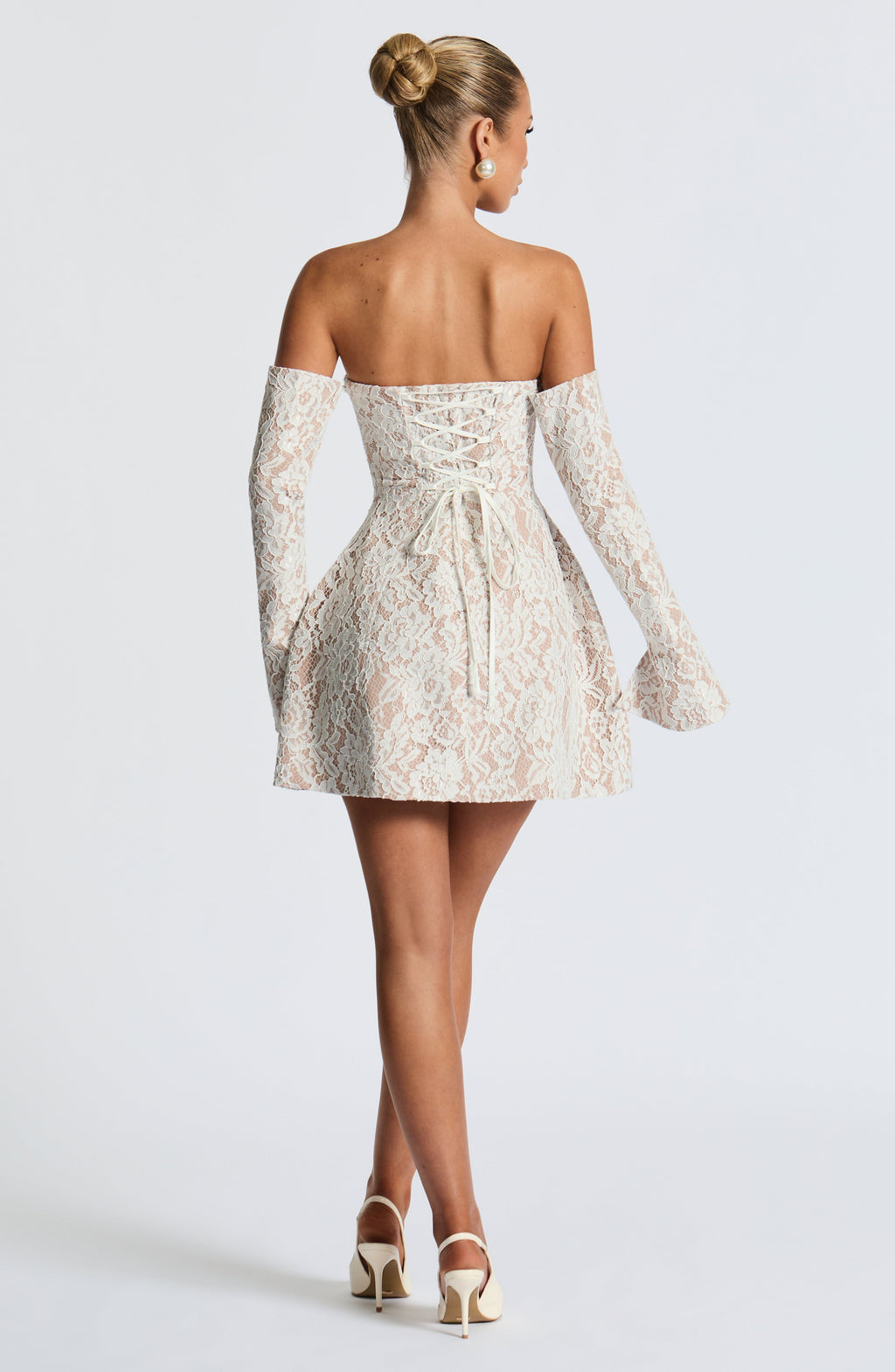 Strapless white lace mini dress over nude lining with separate long flared lace sleeves and lace-up back - view 3