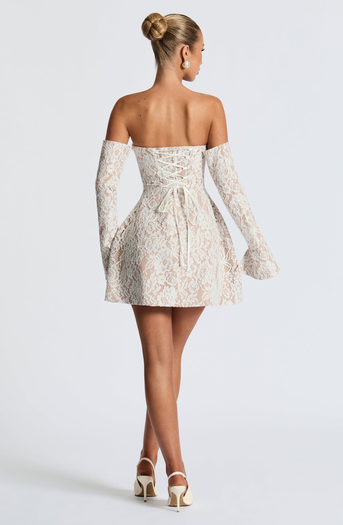 Strapless white lace mini dress over nude lining with separate long flared lace sleeves and lace-up back - view 3