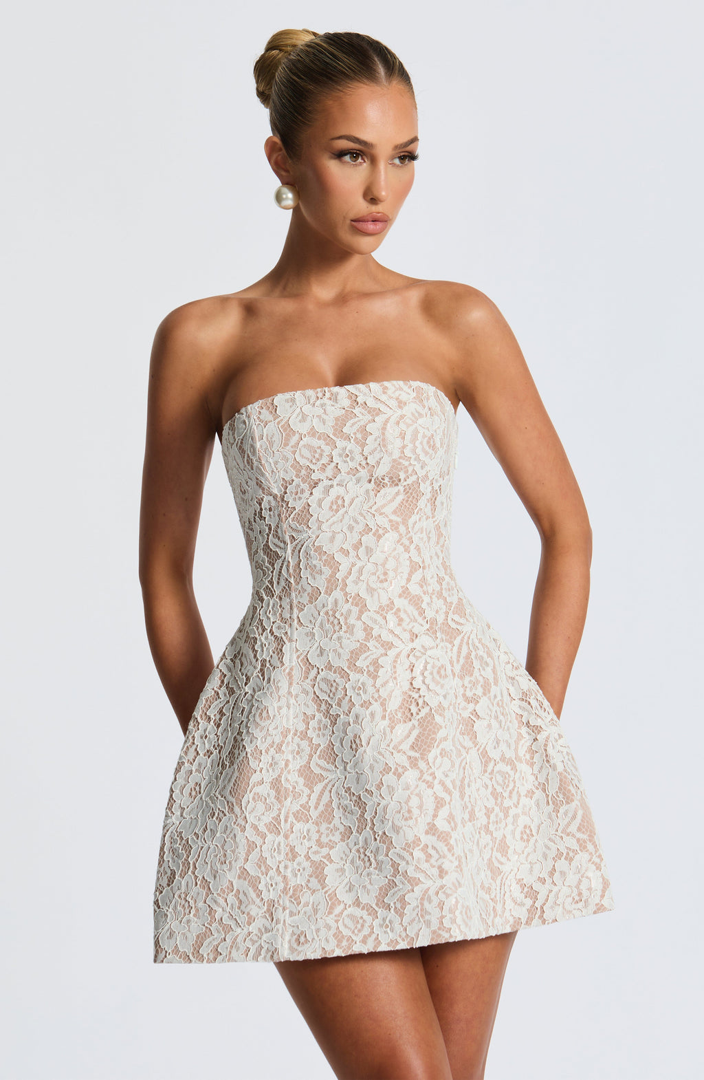 Strapless white lace mini dress over nude lining with separate long flared lace sleeves and lace-up back - view 4