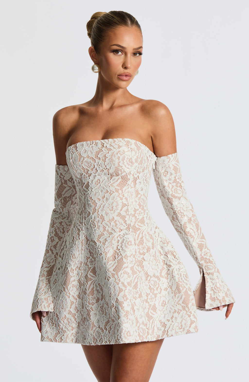 Strapless white lace mini dress over nude lining with separate long flared lace sleeves and lace-up back - view 6