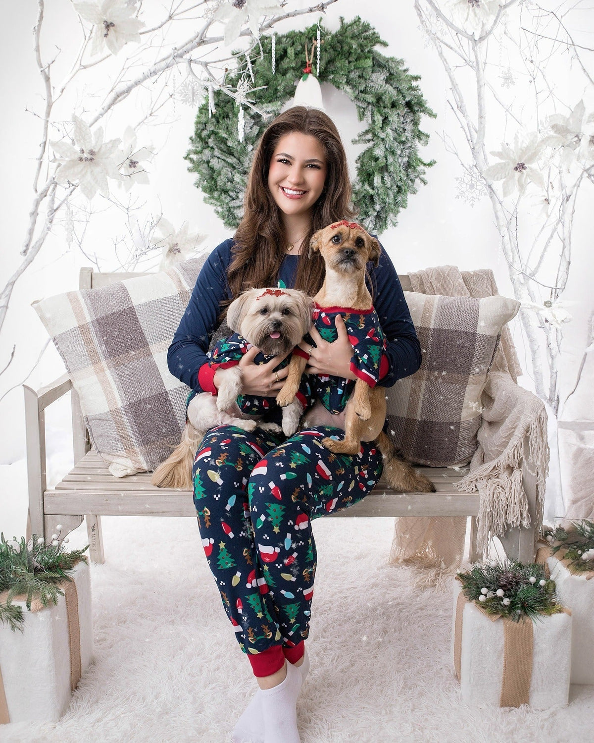 Family wearing matching navy Christmas pajamas with Santa hat graphic tops and holiday print pants - view 7