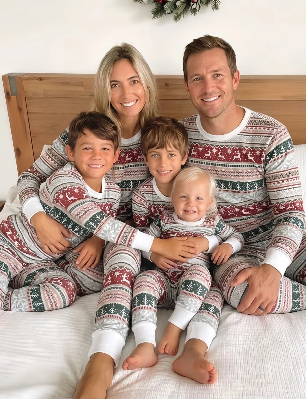 Family wearing matching Fair Isle Christmas pajamas with reindeer print and white cuffs - view 3