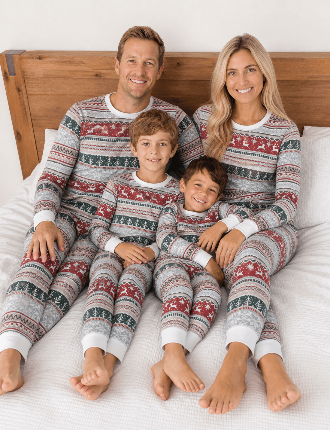 Family wearing matching Fair Isle Christmas pajamas with reindeer and snowflake print and white cuffs - view 5