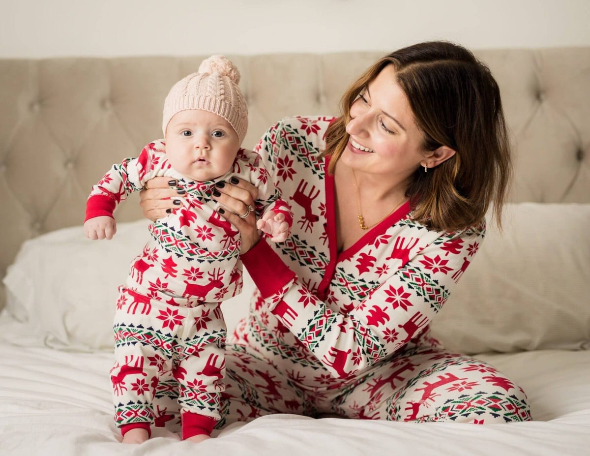 Family wearing matching red and cream reindeer print Christmas pajamas - view 11