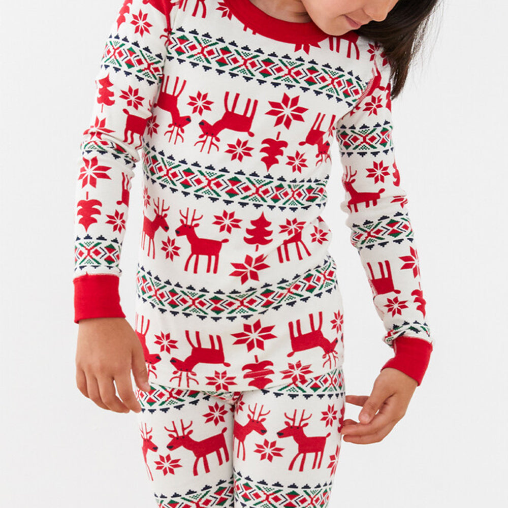 Family wearing matching red and cream reindeer print Christmas pajamas - view 12