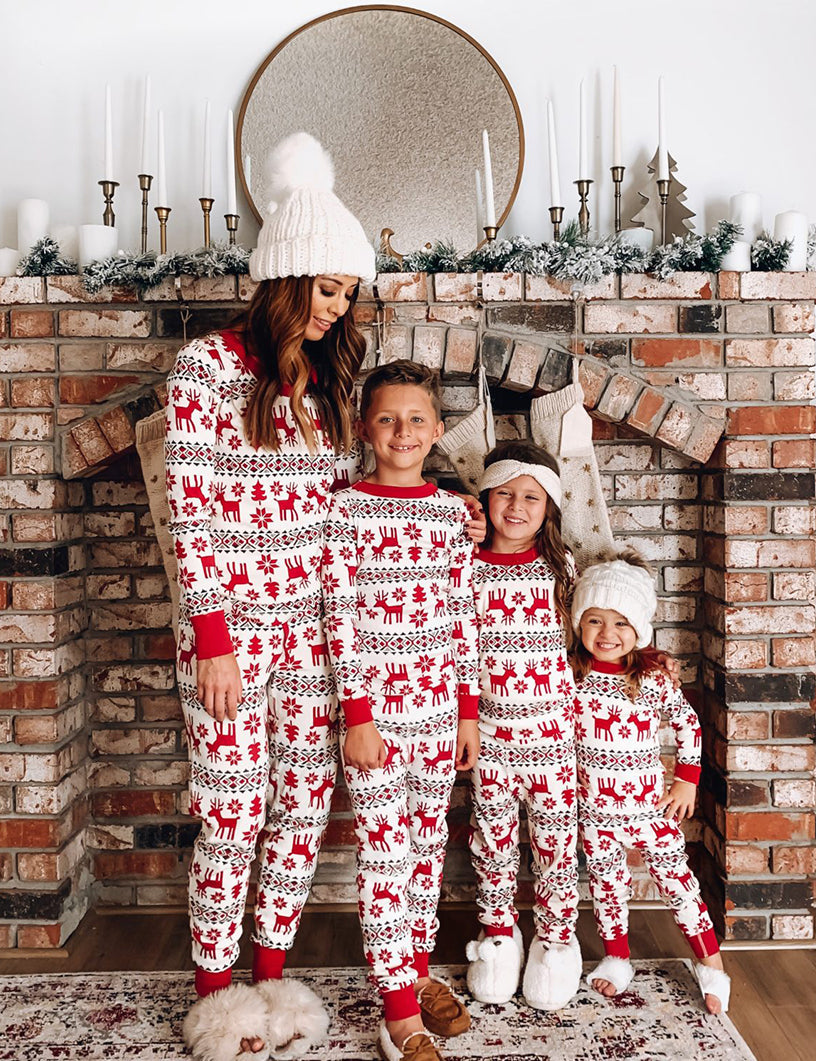 Family wearing matching red and cream reindeer print Christmas pajamas - view 3