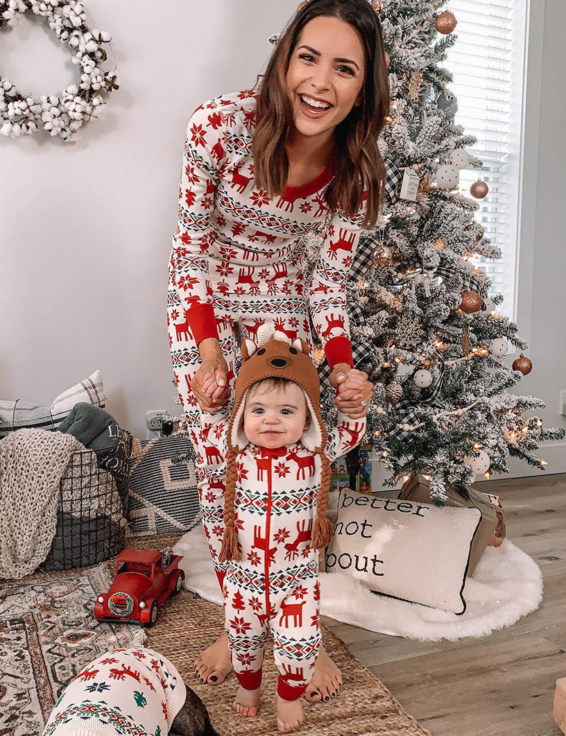 Family wearing matching red and cream reindeer print Christmas pajamas - view 4