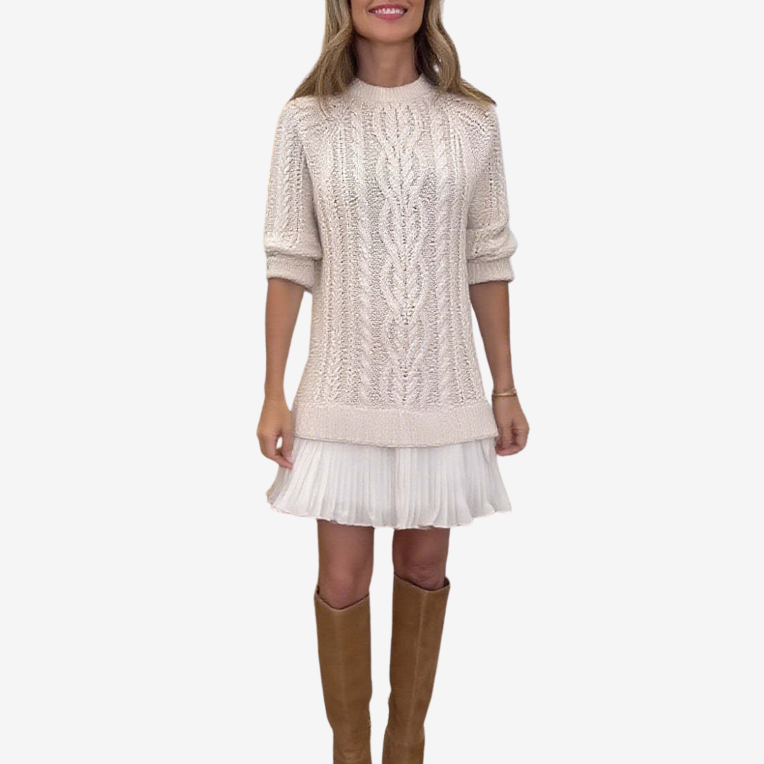 Woman wearing a cable knit sweater dress with a white pleated hem and brown knee-high boots - view 3