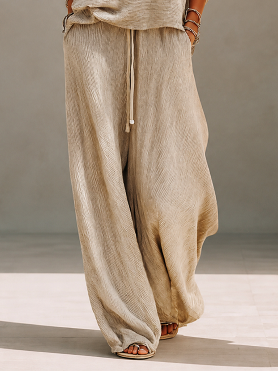 Woman wearing a khaki knit boat neck sweater and matching wide leg drawstring pants - view 7
