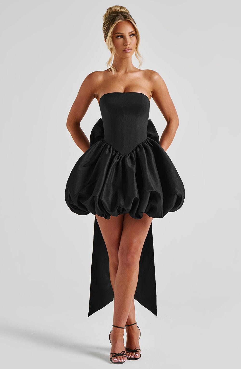 Corset mini dress with bubble skirt and long trailing back bow
