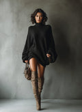 Woman wearing an oversized ribbed turtleneck sweater dress with balloon sleeves and tall boots - view 2