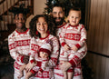 Matching family Christmas pajamas with red and white reindeer and snowflake print